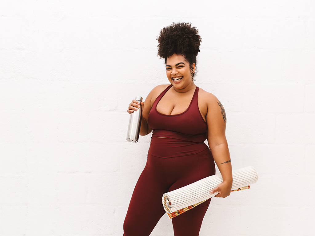 Weight Loss patient smiling with yoga mat Ness weight loss patient smiling, Ness Healthcare